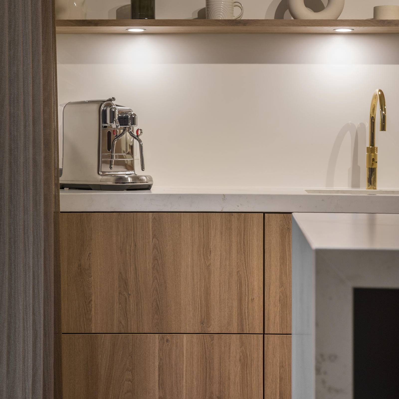Houten greeploze lades met wandplank, ledverlichting en goudkleurige kraan